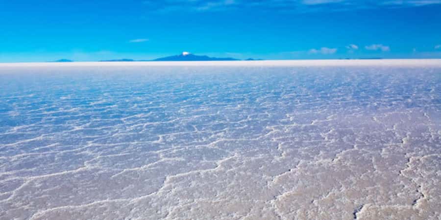 Jeep tracks across the white crust of the Salar de Uyuni