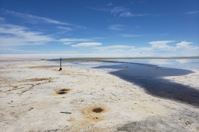 Salar de Uyuni tours 1 day - Salt eyes and water beneath the flat